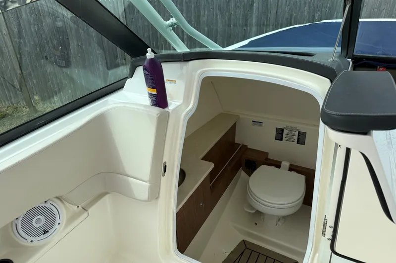Slide: The Image of 2015 Boston Whaler 270 Vantage boat interior with toilet and storage area. - 7