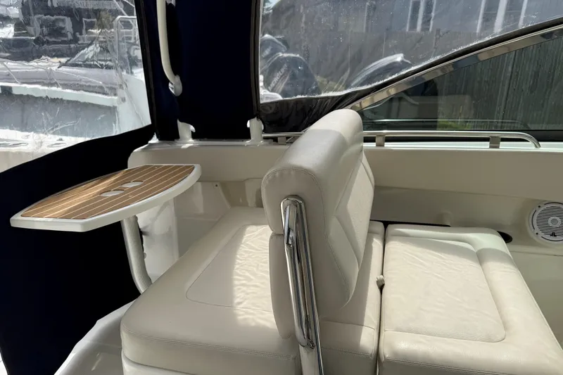 Slide: The Image of Interior of a 2015 Boston Whaler 270 Vantage boat with seating and table. - 9