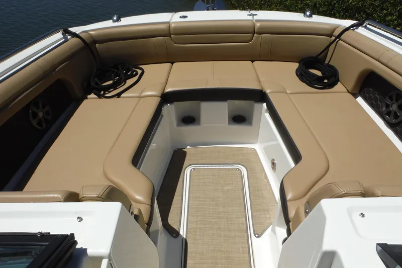 Slide: The Image of 2019 Sea Ray SDX 290 Outboard boat interior with tan seating and deck. - 12