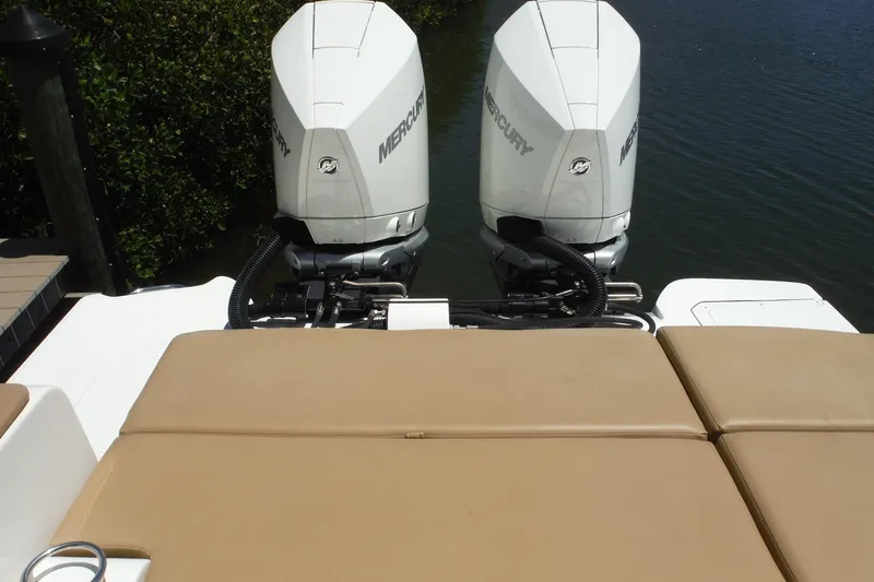 Slide: The Image of 2019 Sea Ray SDX 290 Outboard with twin Mercury engines on a calm waterway. - 20