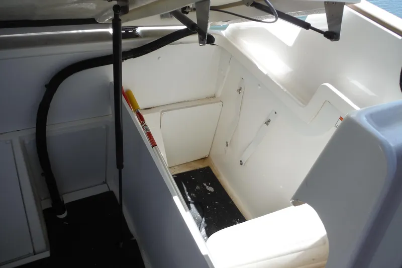 Slide: The Image of 2019 Sea Ray SDX 290 Outboard interior storage compartment with open hatch. - 24