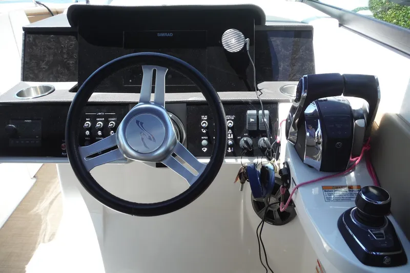 Slide: The Image of 2019 Sea Ray SDX 290 Outboard helm with steering wheel and controls. - 25