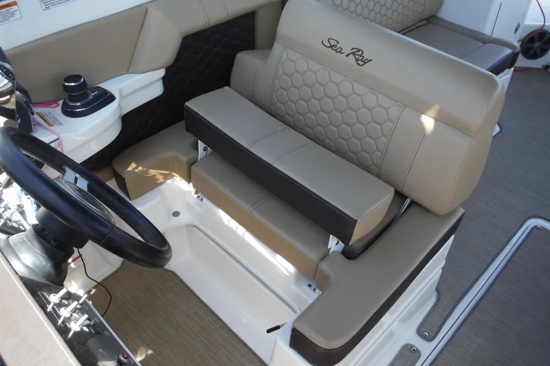 Slide: The Image of 2019 Sea Ray SDX 290 Outboard helm with tan seating and steering wheel. - 27