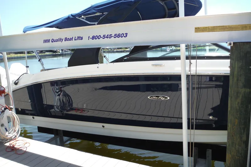 Slide: The Image of 2019 Sea Ray SDX 290 Outboard boat on lift at marina dock. - 3