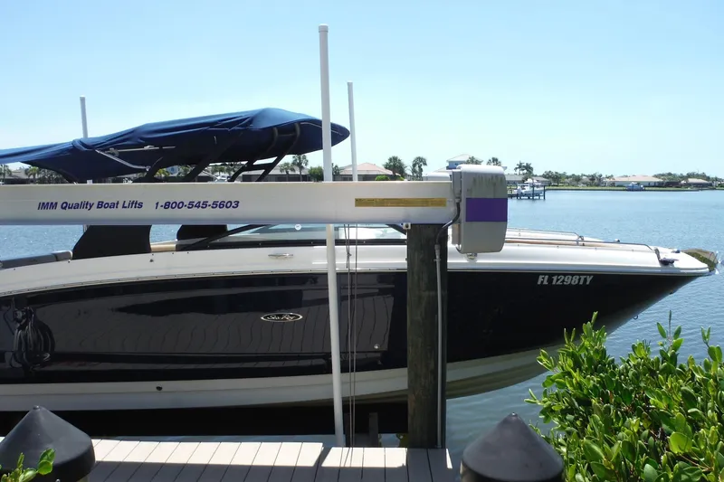 Slide: The Image of 2019 Sea Ray SDX 290 Outboard on boat lift by waterfront. - 4