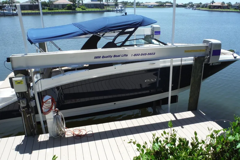 Slide: The Image of 2019 Sea Ray SDX 290 Outboard boat on lift by waterfront dock. - 5