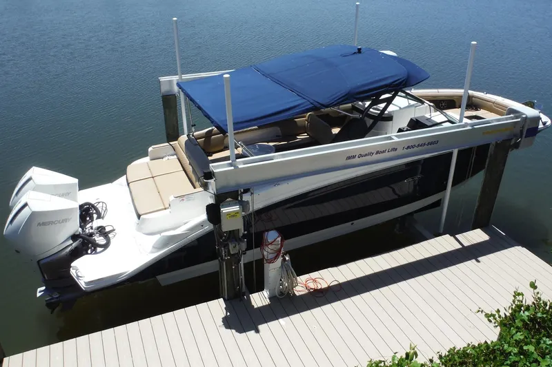 Slide: The Image of 2019 Sea Ray SDX 290 Outboard boat docked with blue canopy and twin Mercury engines. - 7