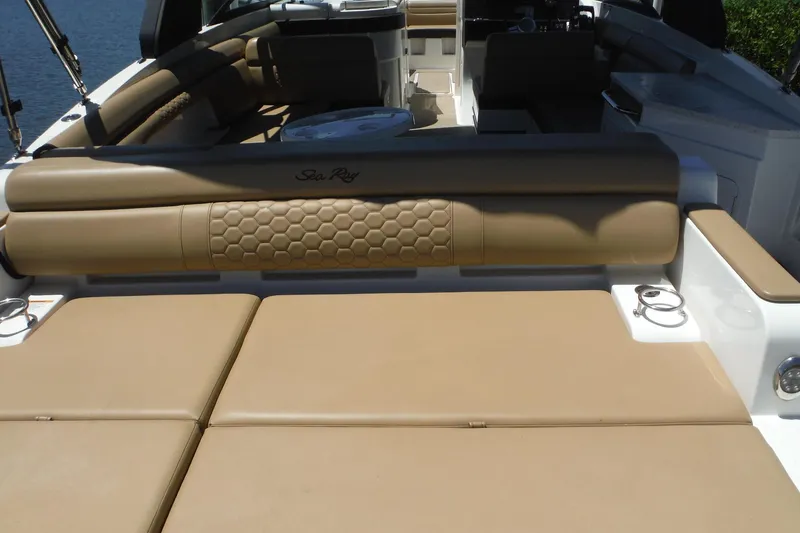 Slide: The Image of 2019 Sea Ray SDX 290 Outboard boat interior with tan seating and elegant design. - 9