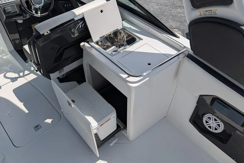 Slide: The Image of 2021 Monterey 255SS Super Sport boat interior with sink and storage compartments. - 11