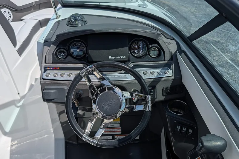 Slide: The Image of Cockpit of 2021 Monterey 255SS Super Sport boat with steering wheel and dashboard controls. - 16