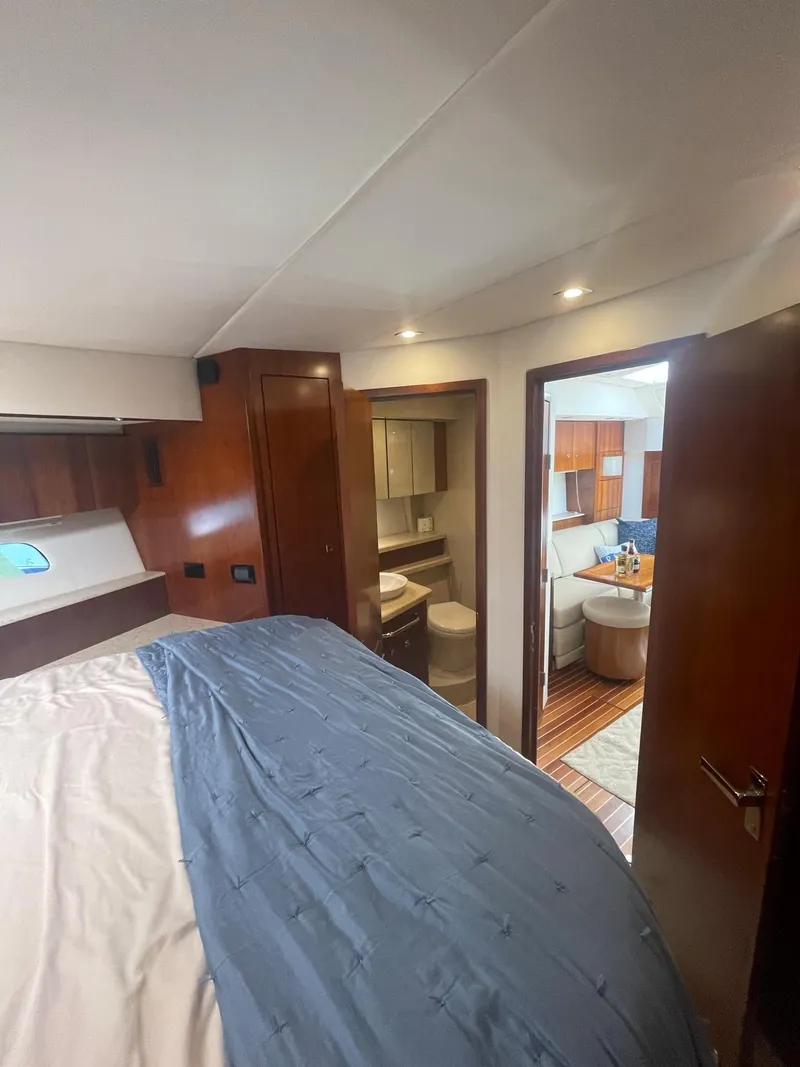 Slide: The Image of Luxurious 2012 Cruisers Yachts 48 Cantius interior with elegant wood finishes and cozy bedroom. - 16