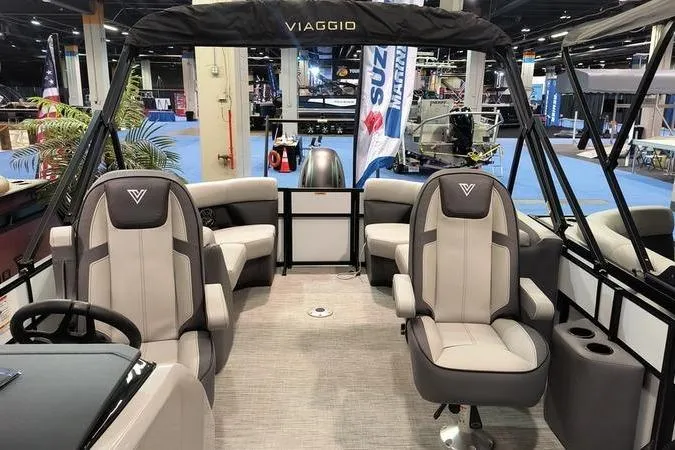 Slide: The Image of Interior of 2026 Viaggio V22U pontoon boat at a boat show display. - 5