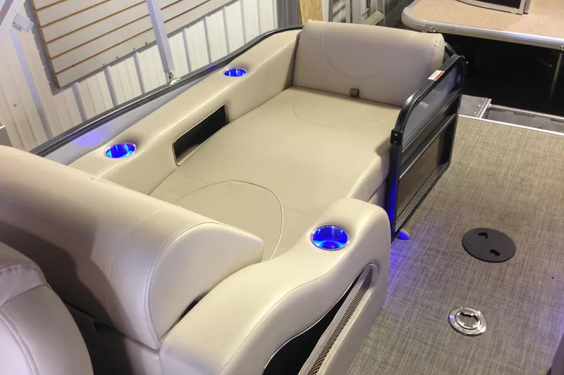 Slide: The Image of 2016 Misty Harbor 2285 Biscayne Bay RL pontoon boat interior with beige seating and blue cup holders. - 17