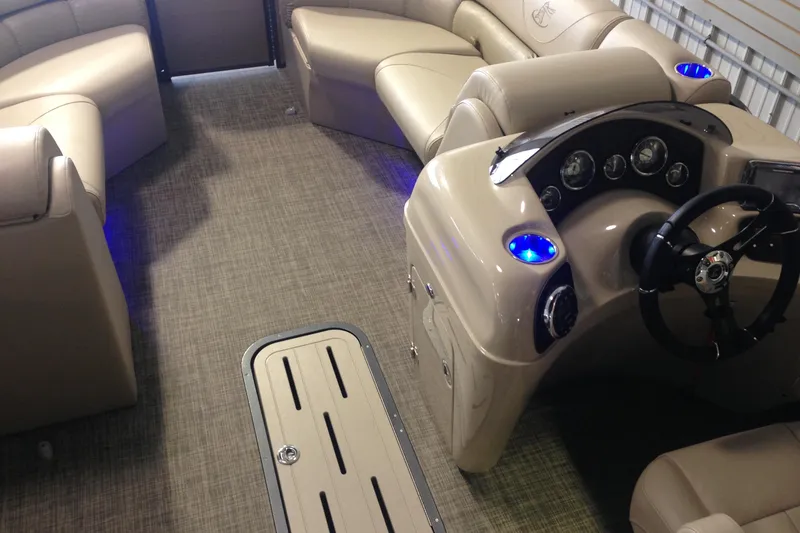 Slide: The Image of Interior of 2016 Misty Harbor 2285 Biscayne Bay RL pontoon boat with beige seating and dashboard. - 18