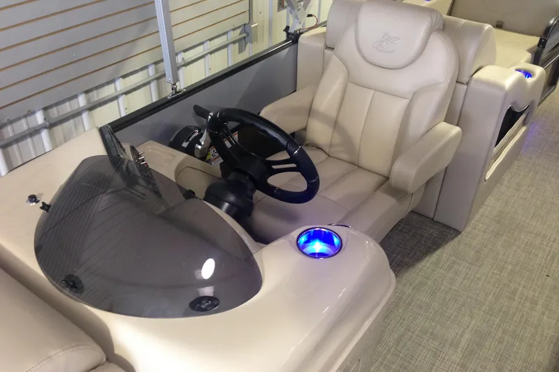 Slide: The Image of 2016 Misty Harbor 2285 Biscayne Bay RL boat interior with beige seating and steering console. - 24