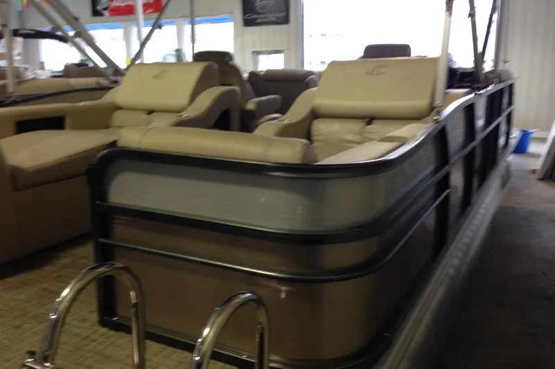Slide: The Image of 2016 Misty Harbor 2285 Biscayne Bay RL pontoon boat with beige seating in a showroom. - 30
