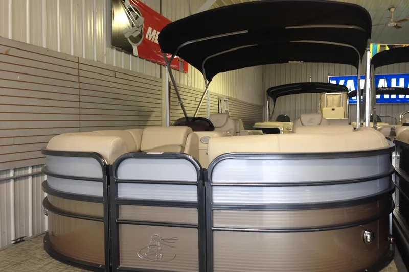 Slide: The Image of 2016 Misty Harbor 2285 Biscayne Bay RL pontoon boat in showroom, featuring beige seating and canopy. - 31