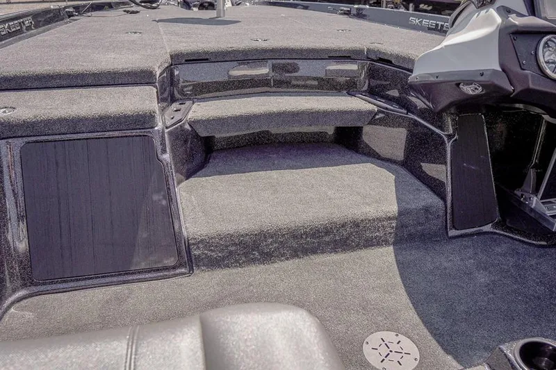 Slide: The Image of 2026 Skeeter ZXR20 SE boat interior with carpeted deck and storage compartments. - 22
