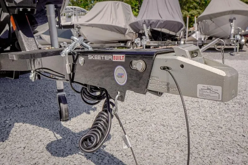 Slide: The Image of Trailer hitch of 2026 Skeeter ZXR20 SE boat on gravel lot. - 49