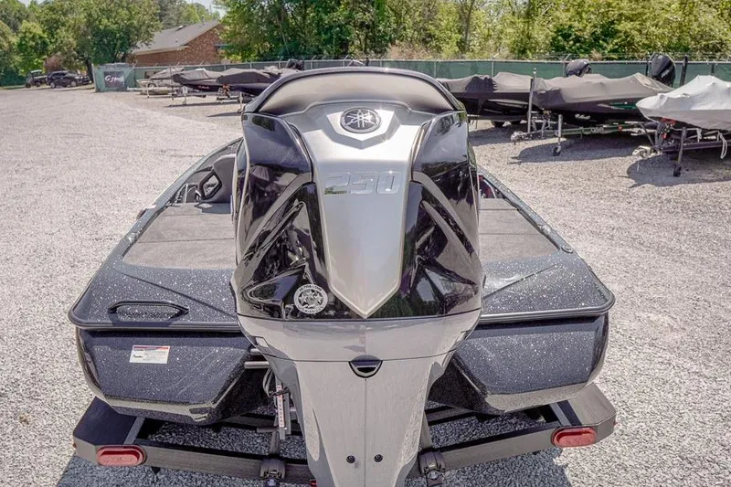 Slide: The Image of 2026 Skeeter ZXR20 SE boat with powerful 250 engine, parked on gravel lot. - 6