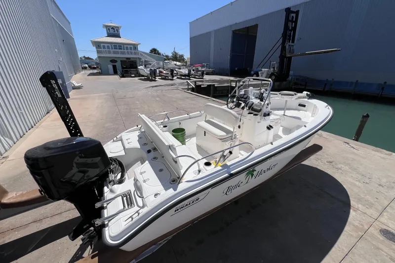 Slide: The Image of 2004 Boston Whaler 180 Dauntless boat on dock, side view, sunny day. - 5