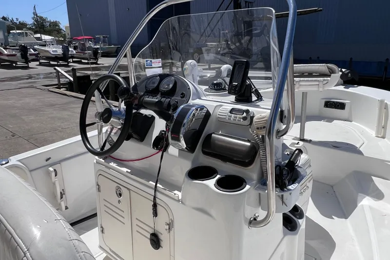 Slide: The Image of 2004 Boston Whaler 180 Dauntless boat docked at a marina, sunny day. - 6