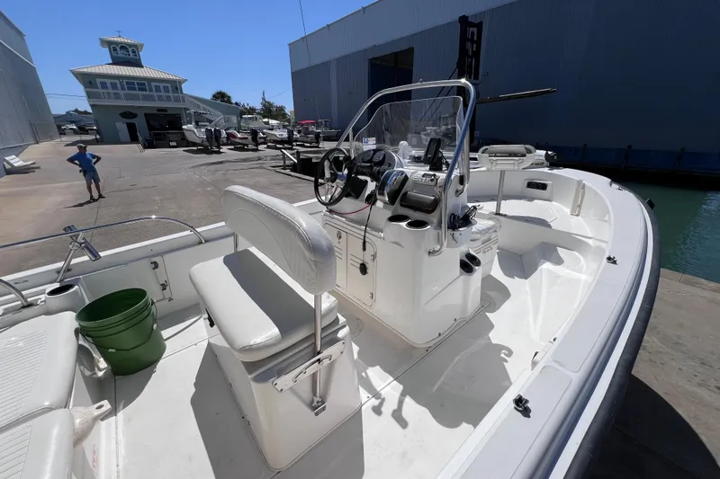 Slide: The Image of 2004 Boston Whaler 180 Dauntless boat docked at a marina, interior view. - 7