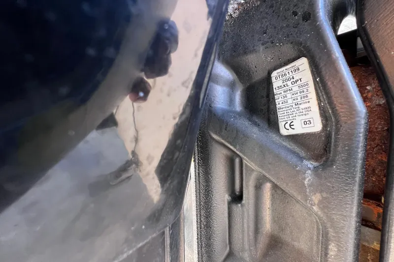 Slide: The Image of 2004 Boston Whaler 180 Dauntless boat cockpit with steering wheel and control panel. - 8