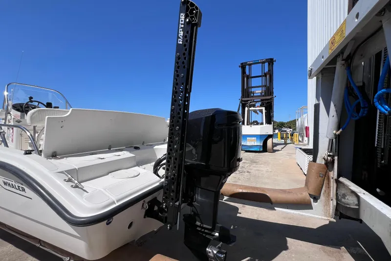 Slide: The Image of 2004 Boston Whaler 180 Dauntless boat interior with steering wheel and seating. - 9