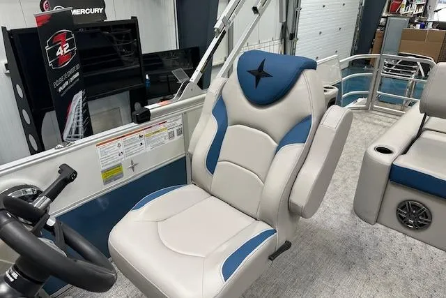 Slide: The Image of Captain's chair in 2025 Berkshire 24UL LE B pontoon boat, featuring blue and white upholstery. - 13