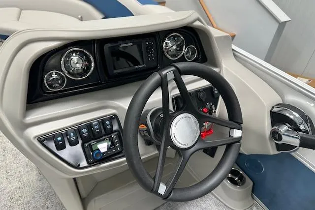 Slide: The Image of 2025 Berkshire 24UL LE B boat dashboard with steering wheel and control panel. - 5