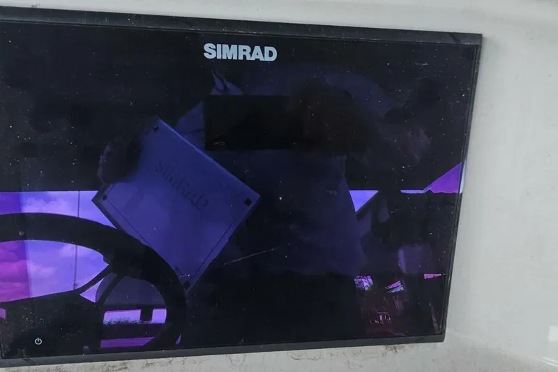 Slide: The Image of Simrad display on 2021 Flats Cat 21' boat dashboard, reflecting steering wheel. - 18