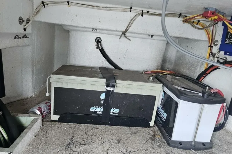 Slide: The Image of Battery compartment of a 2021 Flats Cat 21' boat with wiring and a soda can. - 19