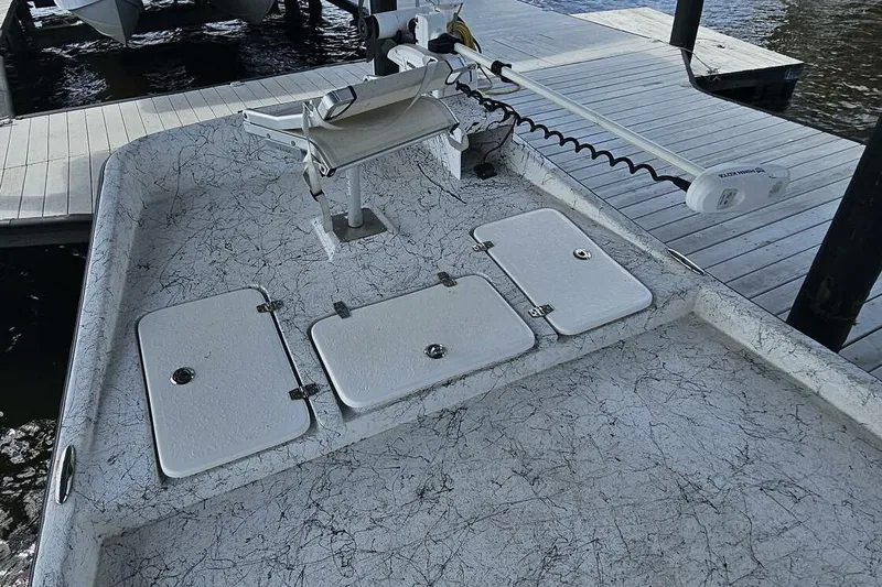 Slide: The Image of 2021 Flats Cat 21' boat deck with storage compartments and trolling motor at dock. - 25