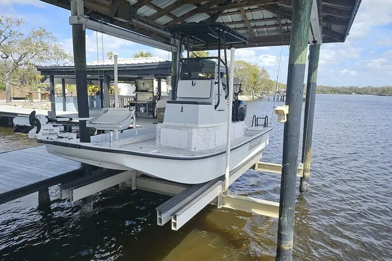 Slide: The Image of 2021 Flats Cat 21' boat docked on a lift over water. - 5