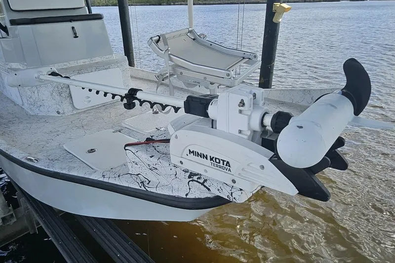 Slide: The Image of 2021 Flats Cat 21' boat with Minn Kota Terrova trolling motor on a calm waterway. - 7