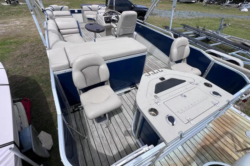 Slide: The Image of 2018 Berkshire 25 STS Tri Toon pontoon boat interior with seating and helm. - 10