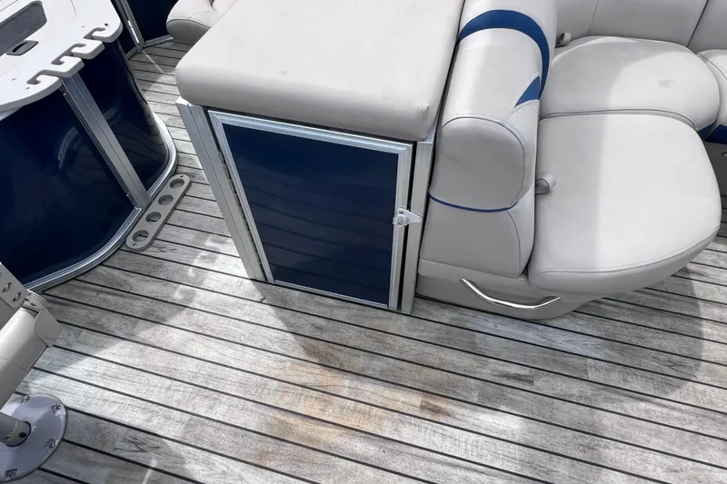 Slide: The Image of 2018 Berkshire 25 STS Tri Toon boat interior with cushioned seating and wooden deck. - 21