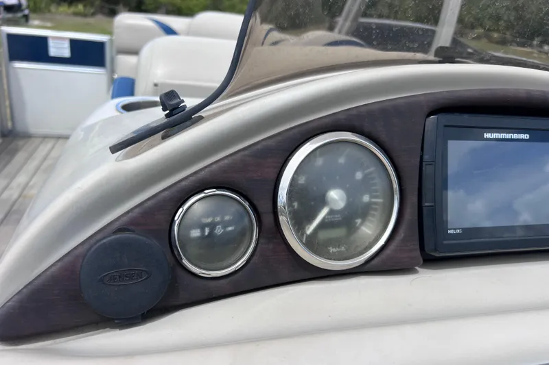 Slide: The Image of Dashboard of 2018 Berkshire 25 STS Tri Toon with gauges and Humminbird display. - 26