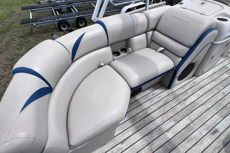 Slide: The Image of 2018 Berkshire 25 STS Tri Toon boat with plush seating on wooden deck. - 28