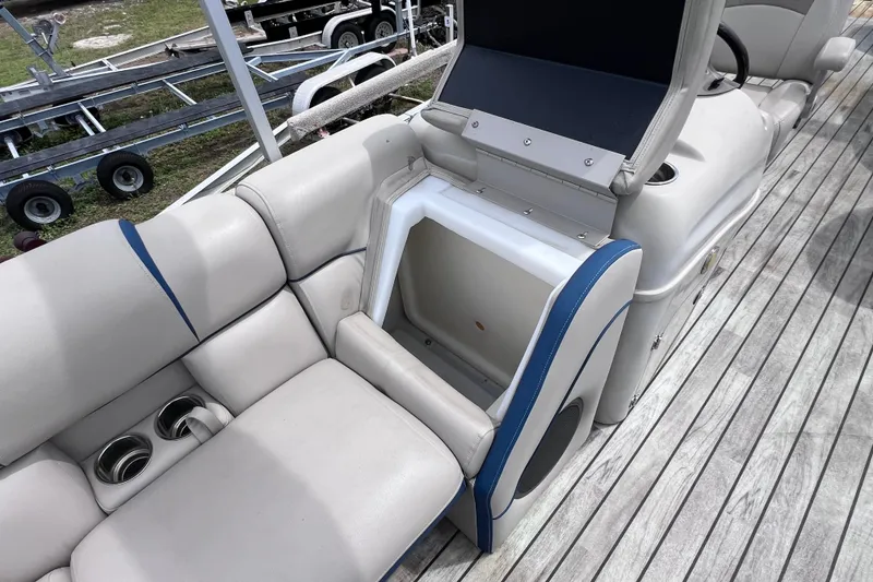 Slide: The Image of 2018 Berkshire 25 STS Tri Toon boat interior with seating and storage compartment. - 29