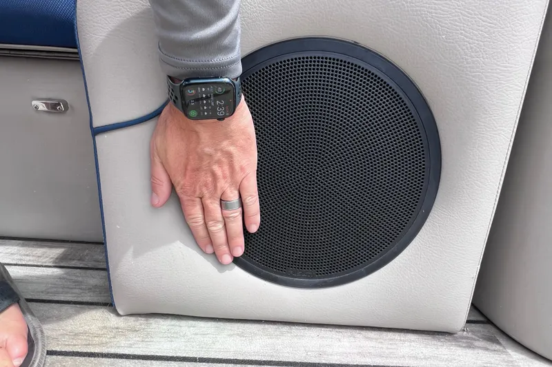 Slide: The Image of Hand on speaker of 2018 Berkshire 25 STS Tri Toon boat interior. - 30