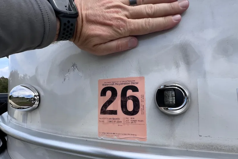 Slide: The Image of Hand on 2018 Berkshire 25 STS Tri Toon with watercraft registration decal. - 37