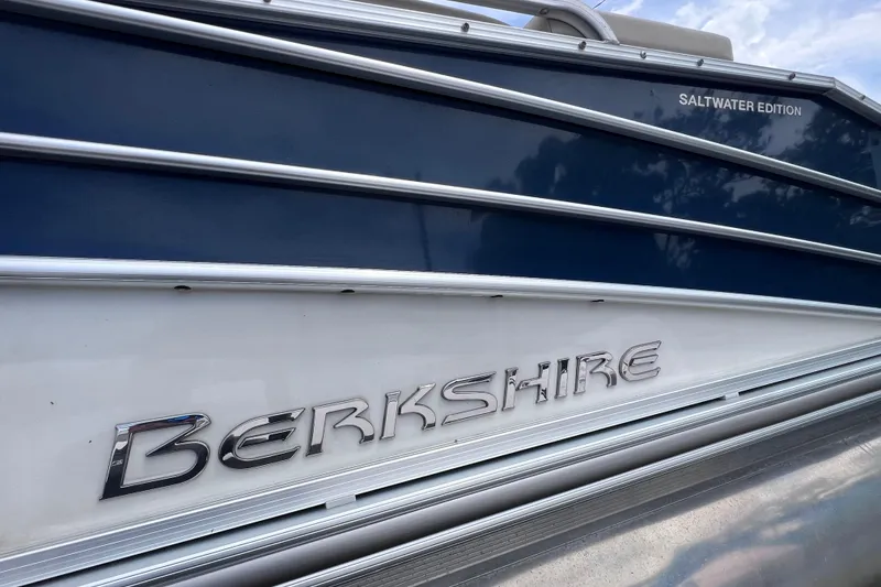 Slide: The Image of 2018 Berkshire 25 STS Tri Toon Saltwater Edition boat, side view with logo. - 7