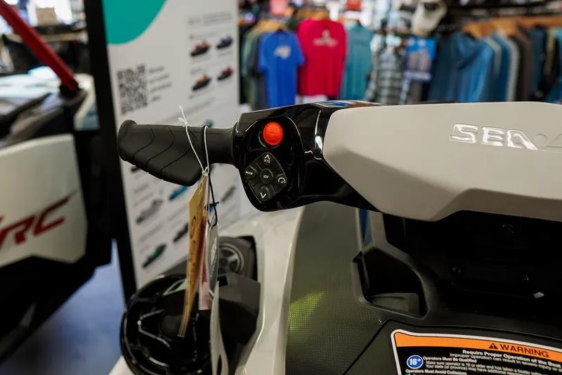 Slide: The Image of 2026 Sea-Doo FishPro Sport 170 handlebar controls in a showroom setting. - 15