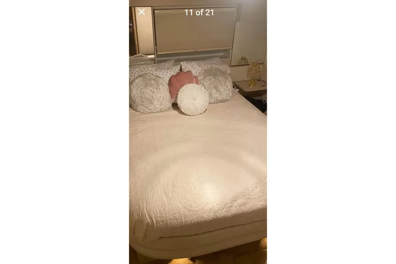 Slide: The Image of Cozy bedroom with decorative pillows on a 1991 Silverton 41 Motor Yacht. - 56