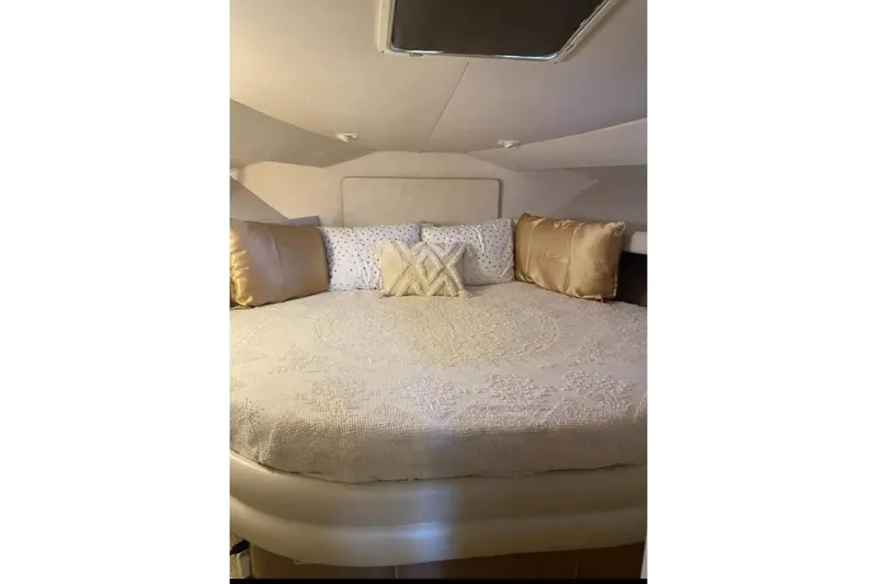Slide: The Image of Cozy bedroom interior of 1991 Silverton 41 Motor Yacht with elegant bedding. - 58