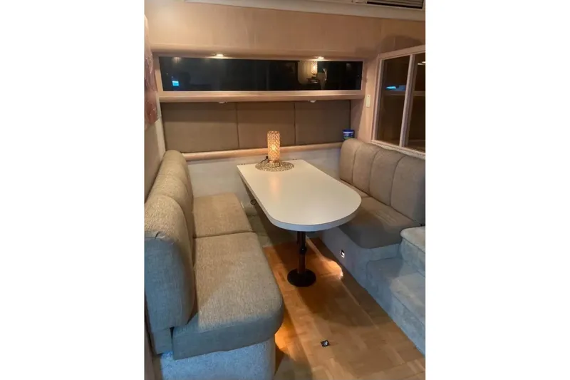 Slide: The Image of Interior of 1991 Silverton 41 Motor Yacht with cozy dining area and cushioned seating. - 61