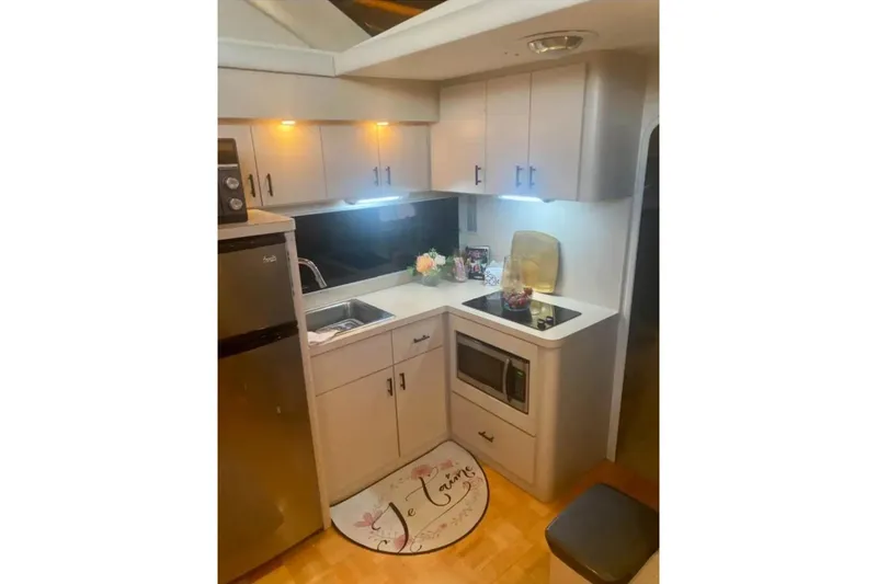 Slide: The Image of Compact kitchen area in a 1991 Silverton 41 Motor Yacht with modern appliances. - 62