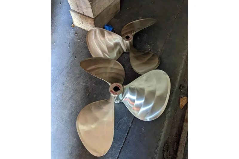 Slide: The Image of Polished boat propellers for 1991 Silverton 41 Motor Yacht on concrete floor. - 69